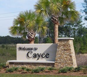 Welcome to Cayee sign board in front of the trees